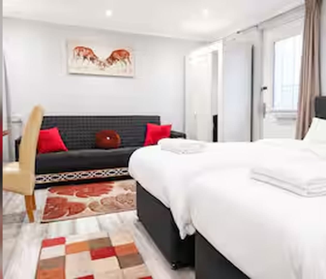 Twin beds and sofa seating area
